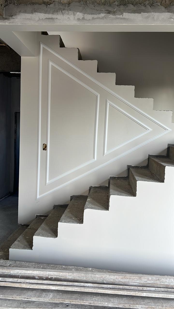 Boiserie geométrica instalada sob escada
